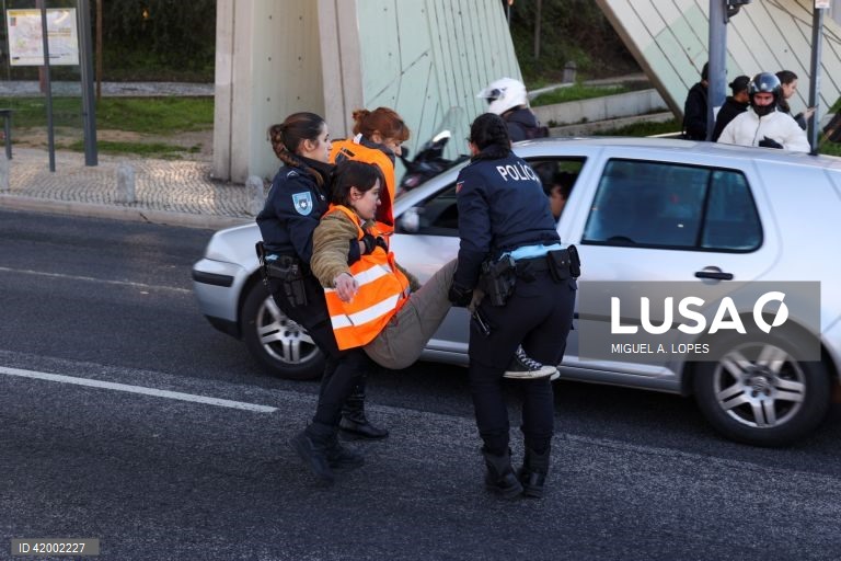 Agentes da Polícia retiram ativistas da Climáximo que bloqueiam o acesso a Lisboa pela A5 durante uma ação de protesto, 14 de dezembro de 2023. MIGUEL A. LOPES/LUSA
