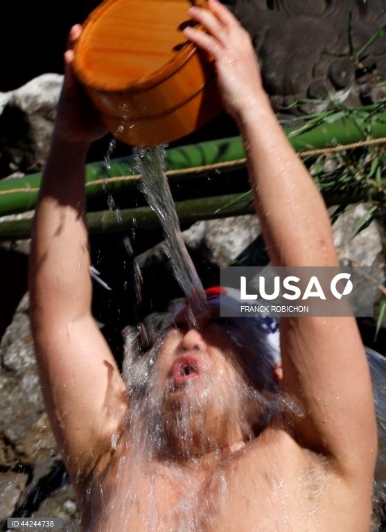 Homens vestidos apenas com tangas banham-se com água gelada para uma cerimónia de purificação no Santuário Kanda Myojin em Tóquio, Japão. Cerca de 40 pessoas participaram no evento anual para rezarem pela sua saúde e se purificarem para o novo ano. 