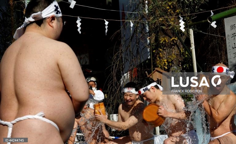 Homens vestidos apenas com tangas banham-se com água gelada para uma cerimónia de purificação no Santuário Kanda Myojin em Tóquio, Japão. Cerca de 40 pessoas participaram no evento anual para rezarem pela sua saúde e se purificarem para o novo ano. 