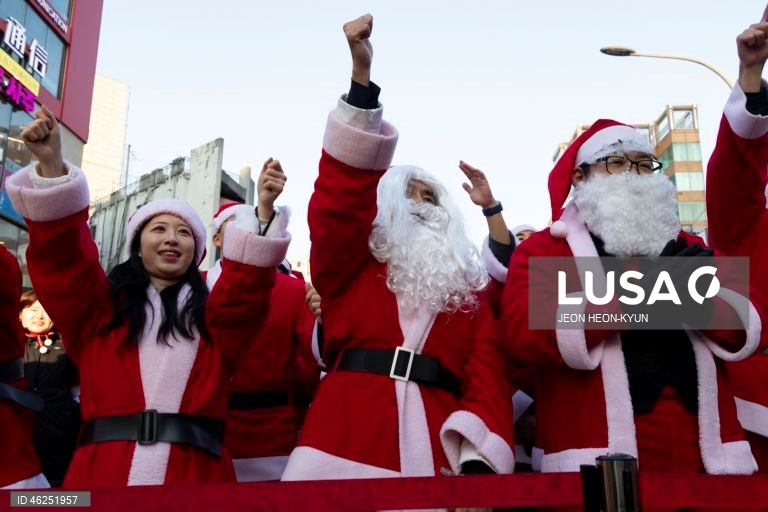 Voluntários sul-coreanos vestidos com trajes de Pai Natal participam de um evento beneficente na véspera de Natal em Seul, Coreia do Sul. A Fundação da Juventude da Coreia organizou o evento, distribuindo presentes a 1.004 crianças carentes.  