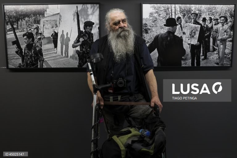 O fotógrafo moravo, Vojta Dukát , junto de fotografias suas durante a visita de imprensa à exposição "Venham Mais Cinco: O Olhar Estrangeiro sobre a Revolução Portuguesa", no Parque Empresarial da Mutela (antiga Lisnave) em Almada, 23 de maio de 2025. TIAGO PETINGA/LUSA