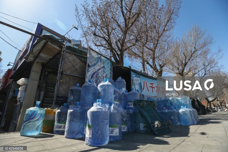 Water delivery worker delivers barreled drinking water in Beijing